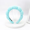 Light blue sponge terry cloth headband for hair styling displayed on a white stand.