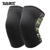 A pair of black knee sleeves with a camouflage accent on the side.