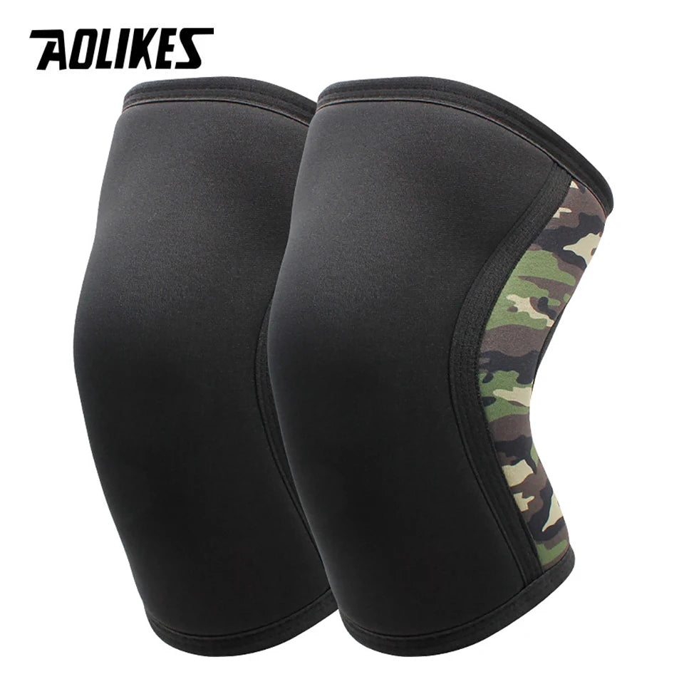 A pair of black knee sleeves with a camouflage accent on the side.