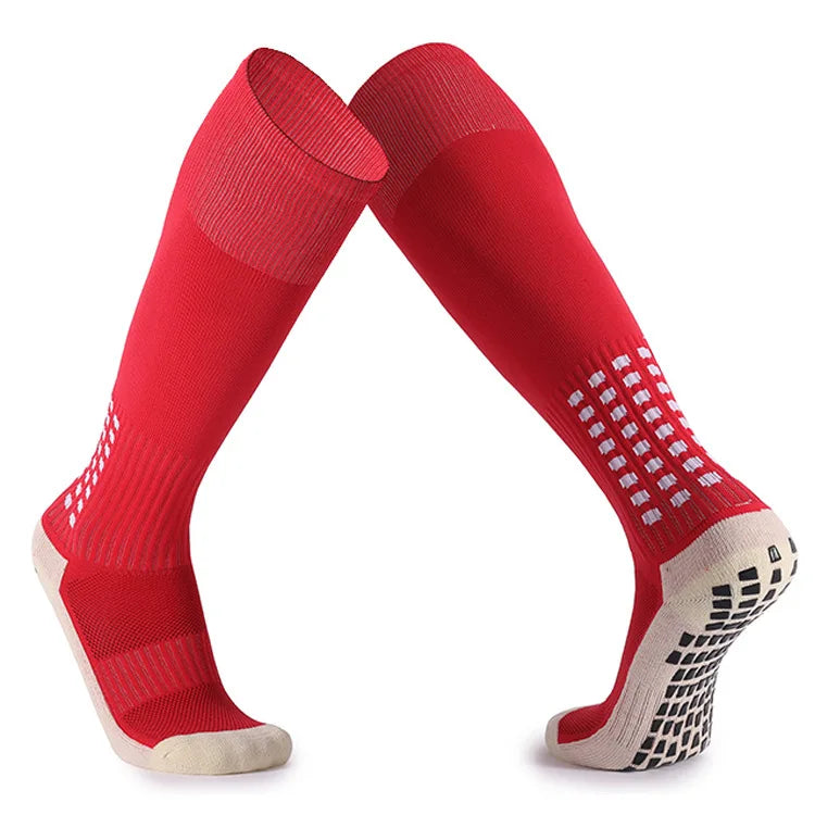 A pair of red football training socks for men shown flat, highlighting the design and cuff.