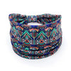 A colorful bohemian stretch cotton headband featuring intricate geometric patterns in blue, green, and orange.