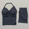 A dark navy women's seamless fitness set consisting of a cropped top and a long-sleeved bottom.