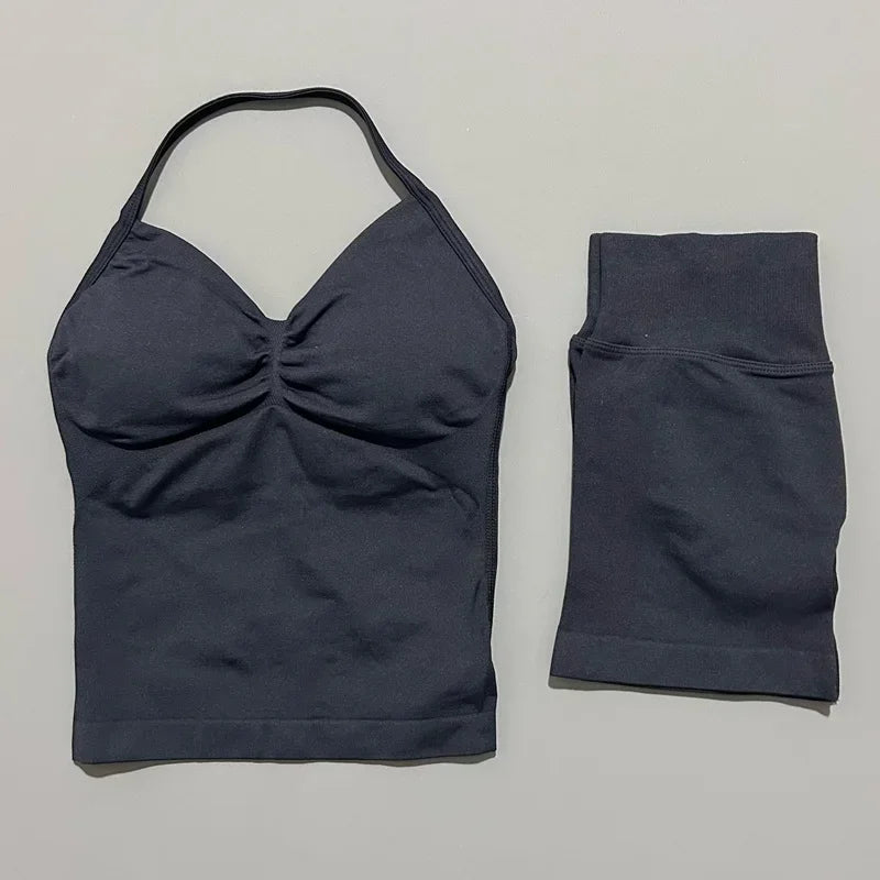 A dark navy women's seamless fitness set consisting of a cropped top and a long-sleeved bottom.