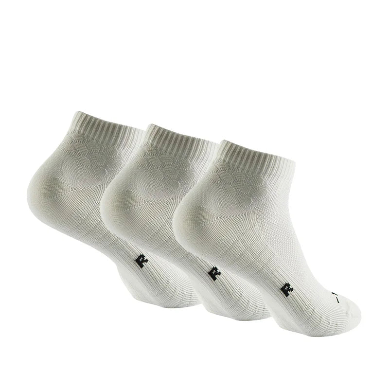 A set of white performance ankle socks for running and athletic activities