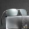 Silver photochromic polarized sunglasses resting on a dark gray leather case.