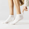 A close-up shot of a person's leg wearing white men's combed cotton socks.