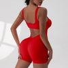 A model wearing a red tie-dye sport jumpsuit from the back view.