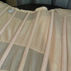A light beige body shaper waist trainer corset made of sheer fabric with vertical pleats.