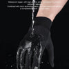 A close-up of a black splash proof fabric glove being used to repel water.
