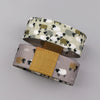 A beige stretch silicone wristband bracelet featuring a pattern of black sheep silhouettes.