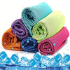 Une pile de serviettes microfibres colorées roulées, avec des glaçons au premier plan.