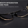 A pair of black sunglasses with gold accents and smooth nose pads resting on a dark surface.