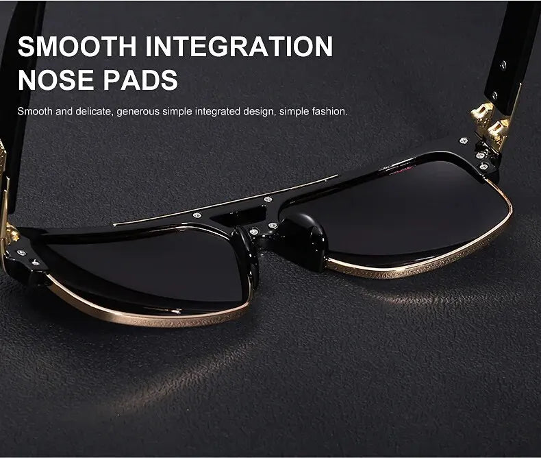 A pair of black sunglasses with gold accents and smooth nose pads resting on a dark surface.