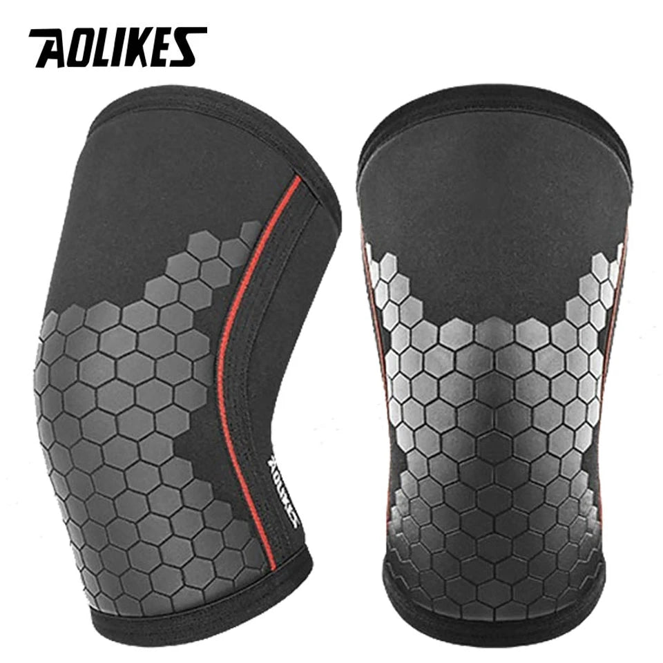 Black knee sleeves with a honeycomb pattern and red trim for weightlifting