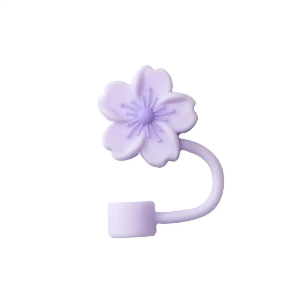 A purple silicone butterfly straw cover for tumblers.