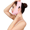 A woman is applying a pink face slimming lifting strap to her jawline.
