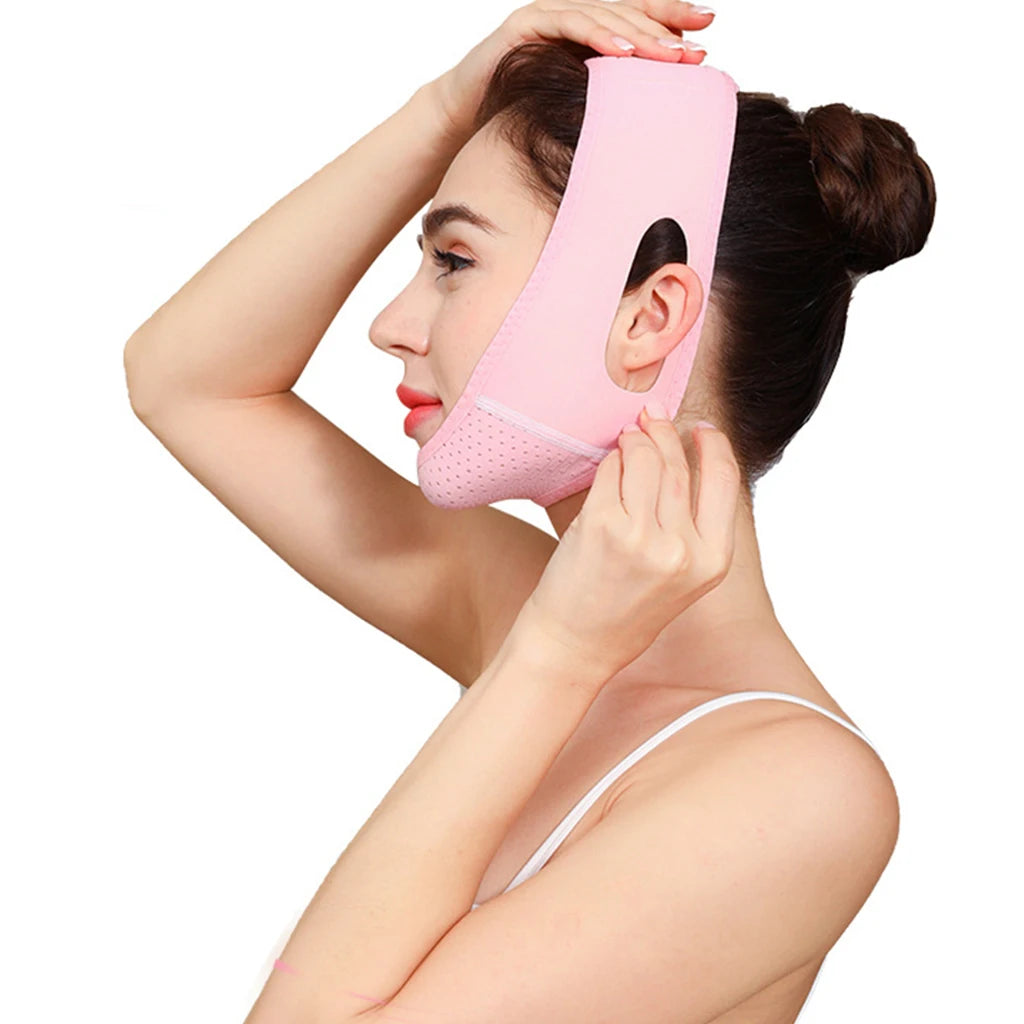 A woman is applying a pink face slimming lifting strap to her jawline.