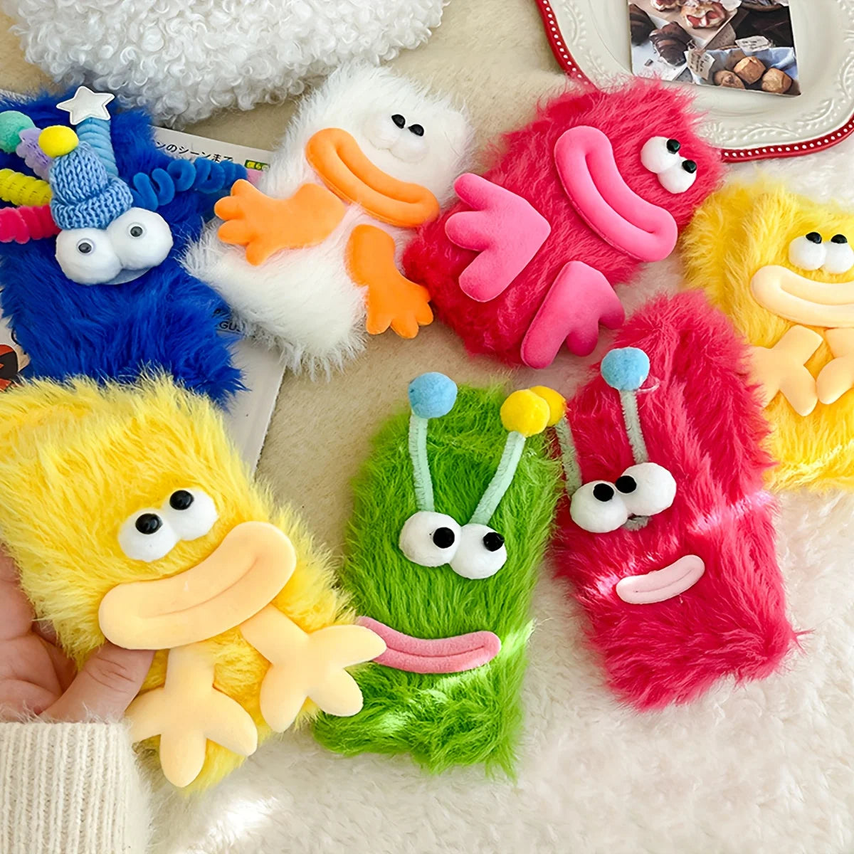A collection of colorful plush caterpillar-themed floor socks featuring various bright colors like blue, pink, yellow, and gr