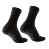 A pair of black athletic grip socks shown from the side.