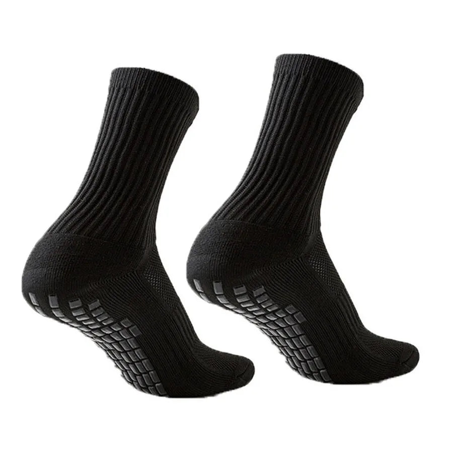 A pair of black athletic grip socks shown from the side.