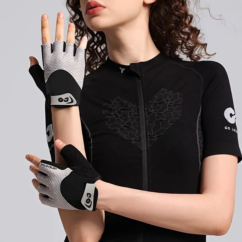 A close-up of a person wearing black cycling gloves with gray accents and a mesh palm.