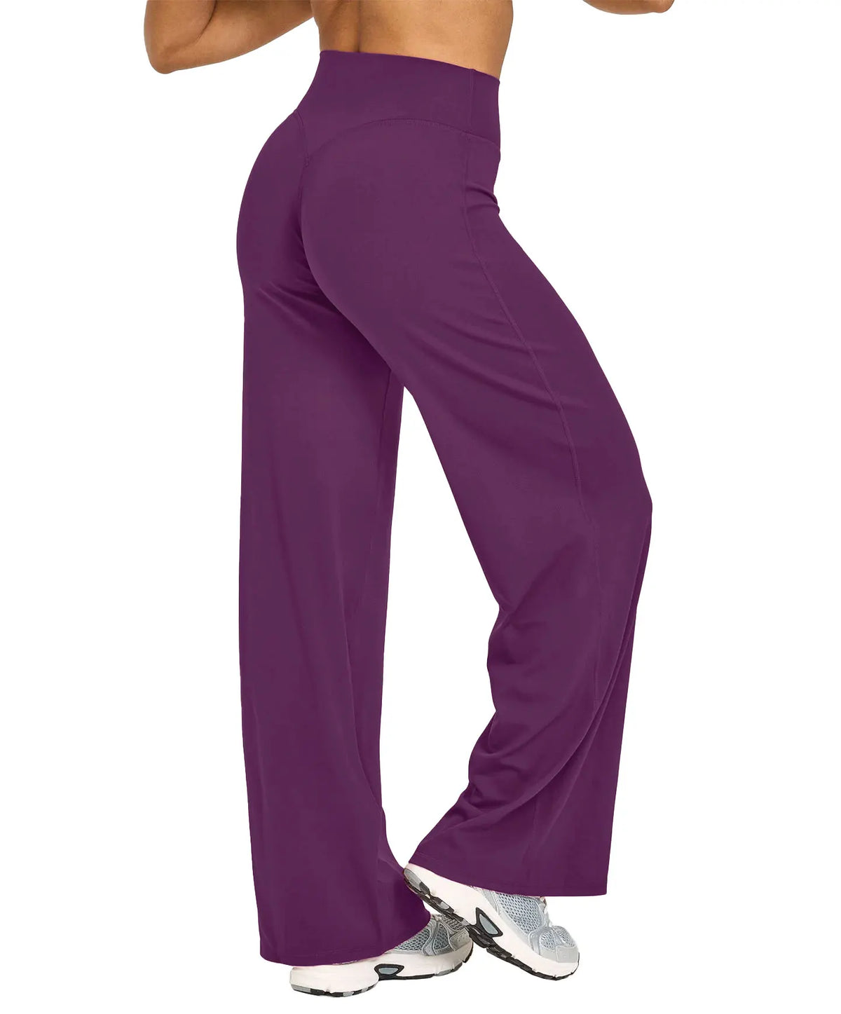 A model is wearing purple high-waist yoga pants and white athletic shoes.