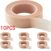 A set of ten rolls of pink eyelash extension tape for precision application.