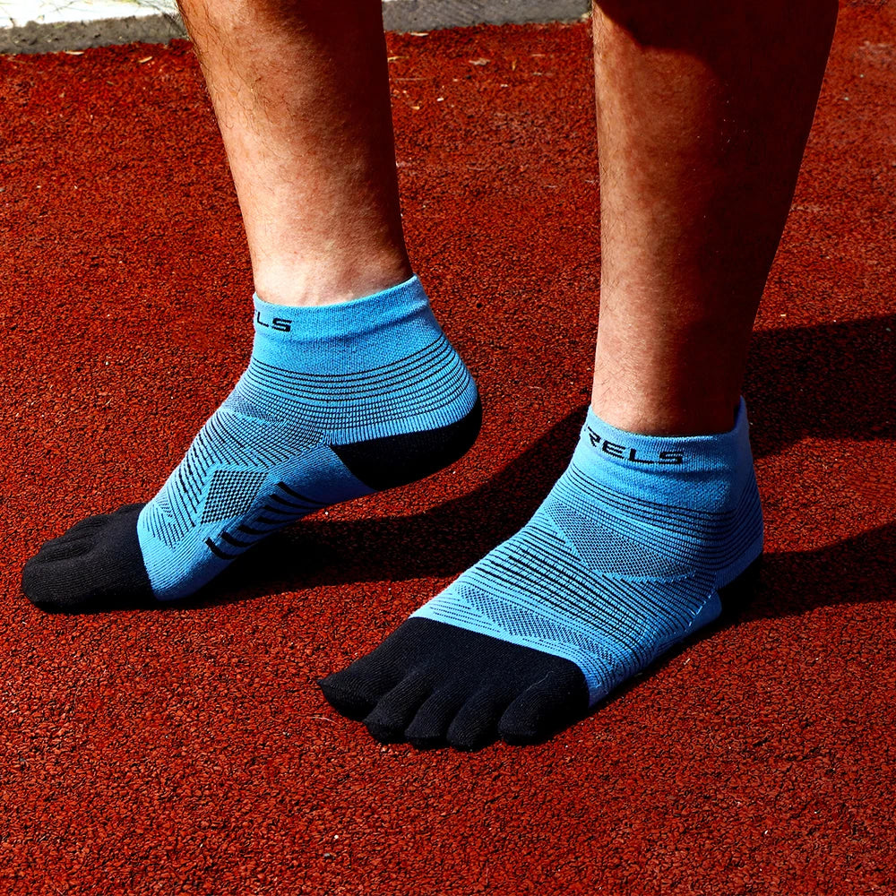 A pair of blue compression socks worn on a person's feet, resting on a red surface.