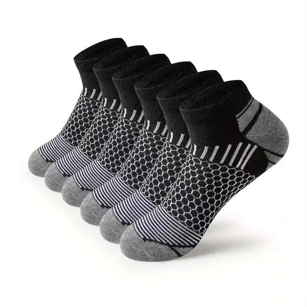 A stack of black and gray athletic knit ankle socks for men displayed on a white background.