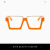 A pair of orange oversized square semi-rim metal eyeglasses viewed from the front.