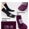 Close-up display of dark purple and black professional cycling socks showing brand identity and size markings