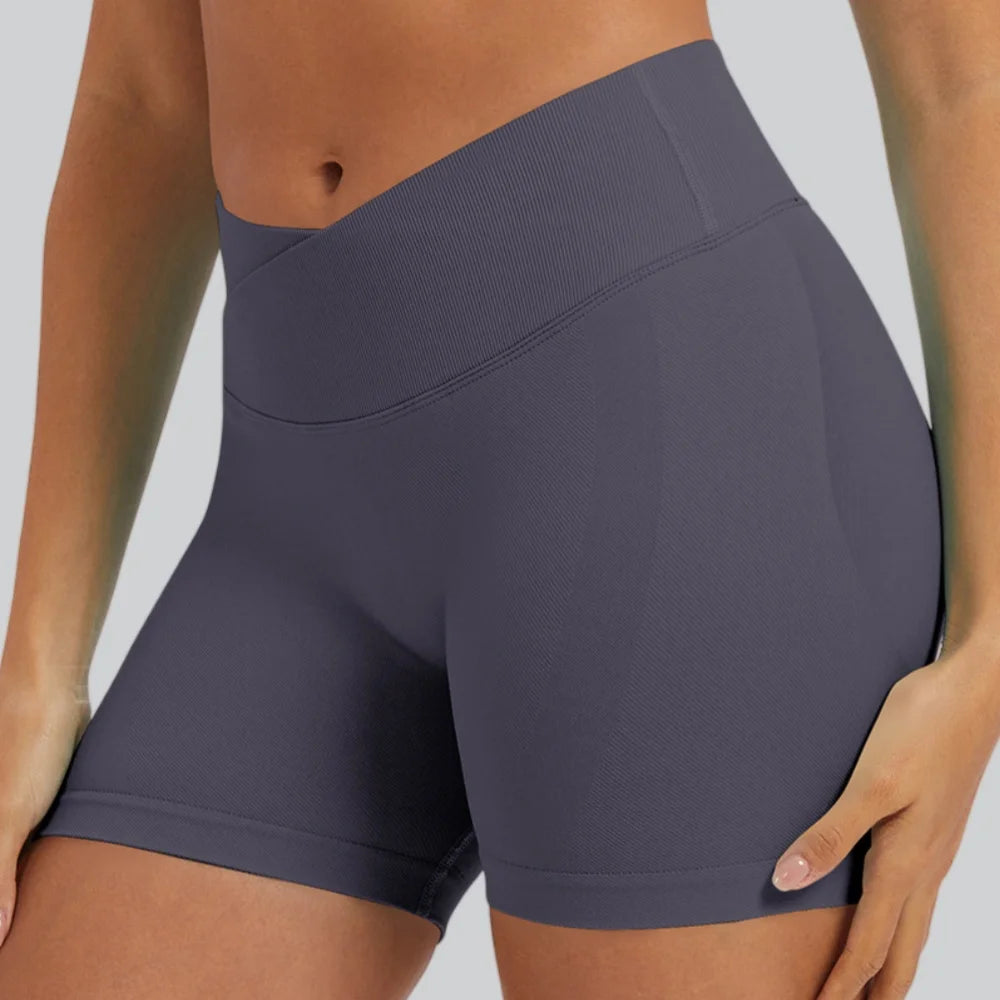 A model is wearing a solid gray seamless high-waist yoga legging in a fitted, athletic style.