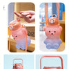 Pink bear-shaped portable water bottle with a straw and strap shown in various angles.