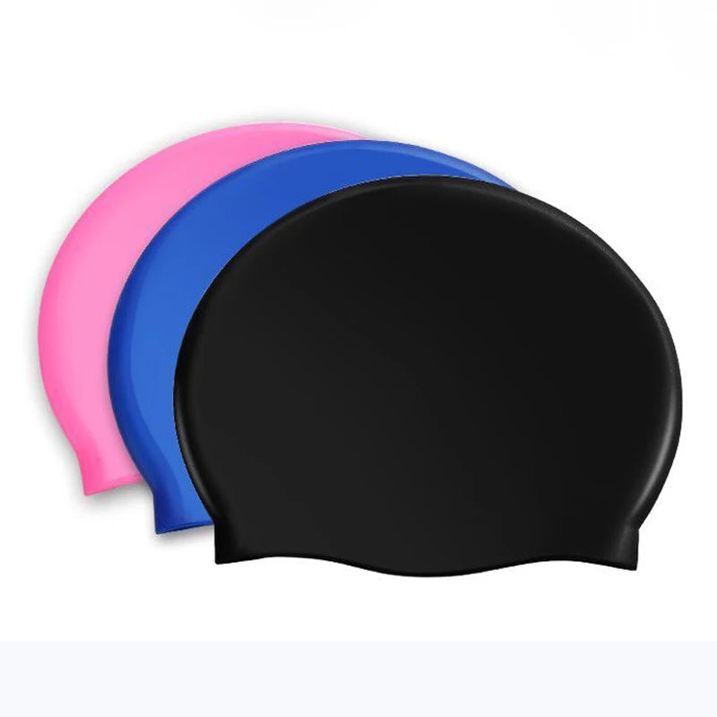 A stack of three waterproof silicone swimming caps in pink, blue, and black.