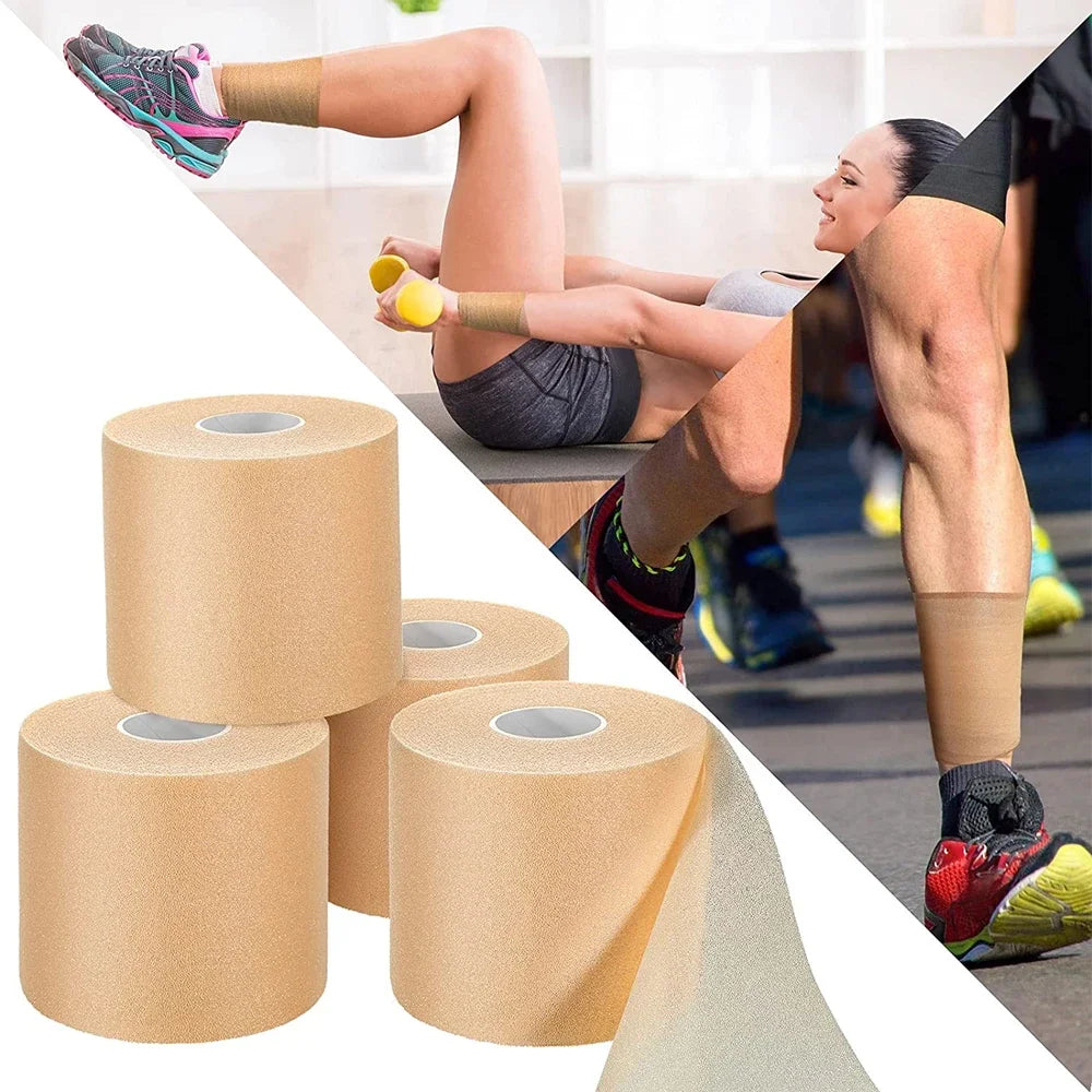 Rolls of athletic binding tape being used for sports injury support on a leg.