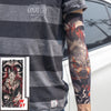 A person wearing a gray t-shirt displays a full sleeve tattoo featuring a fierce wolf head in red and black ink.