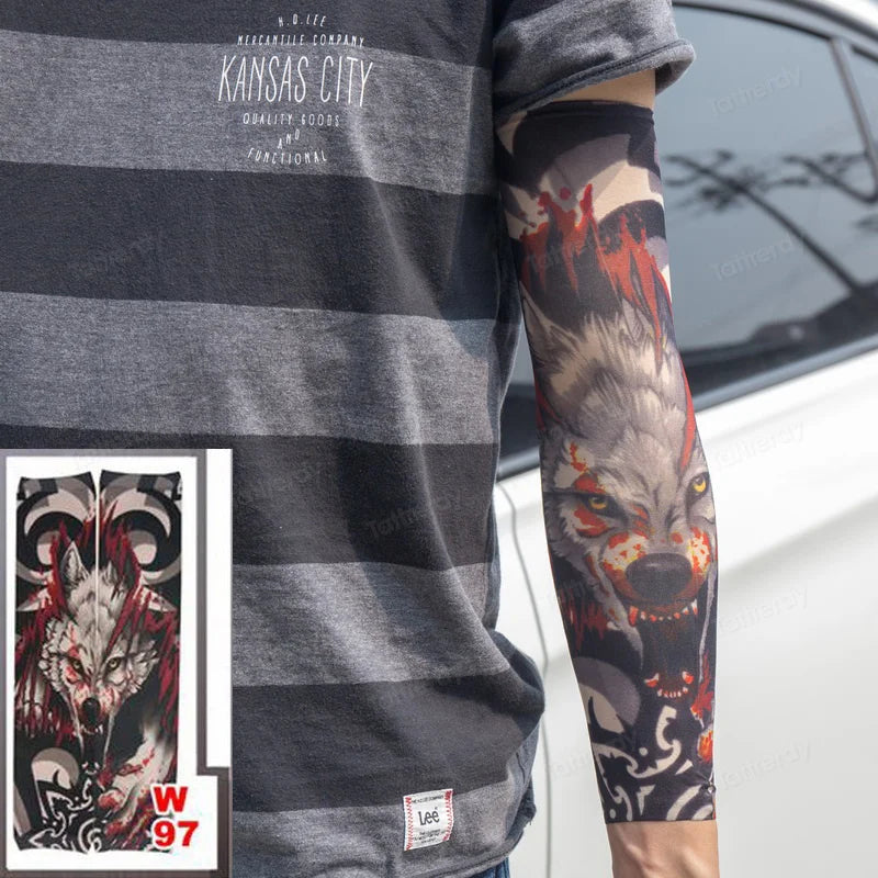 A person wearing a gray t-shirt displays a full sleeve tattoo featuring a fierce wolf head in red and black ink.