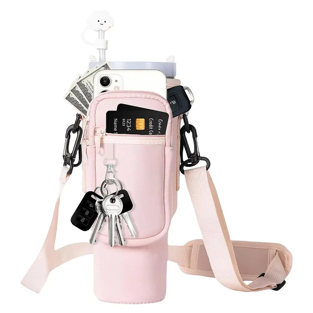 A pink neoprene water bottle carrier bag with a shoulder strap and attached keys is shown.