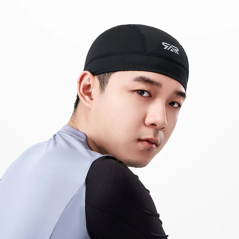 A man wearing a black Quick Dry Cycling Cap with a white logo, shown in a close-up profile view.