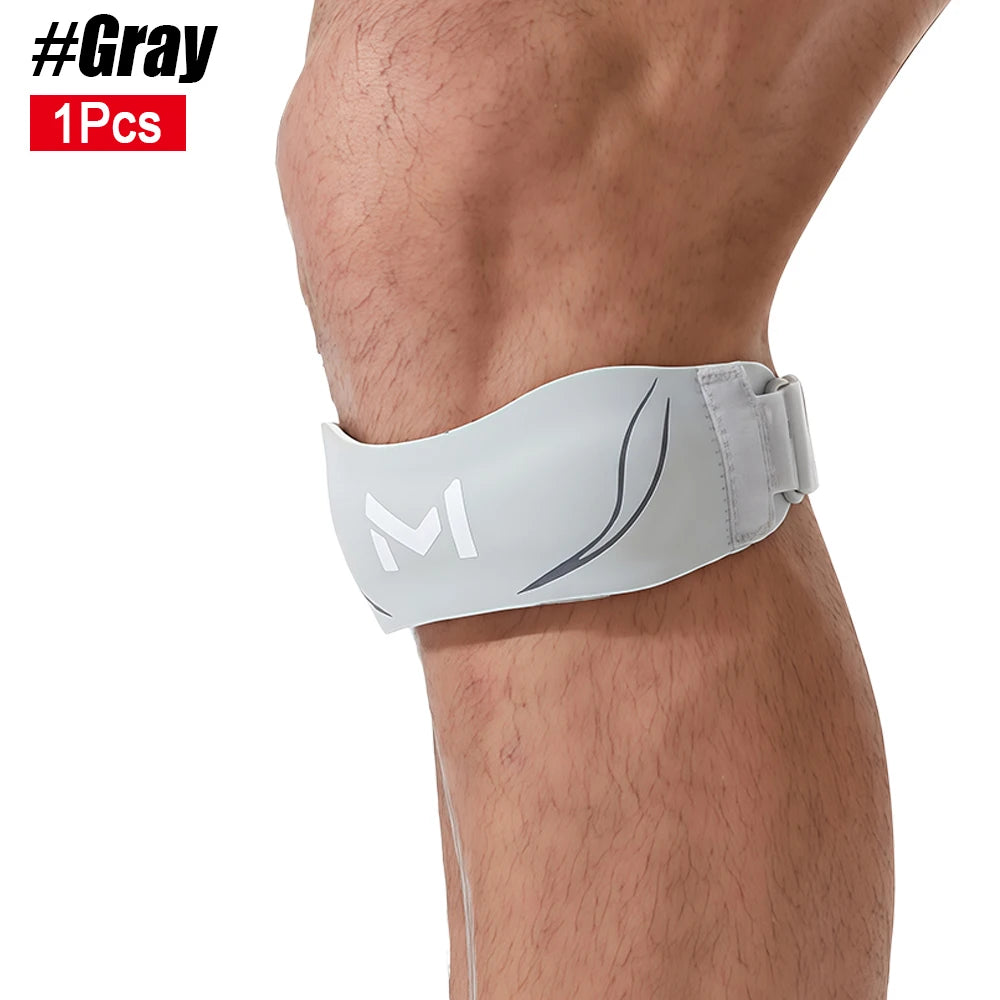 Gray adjustable patellar tendon support knee brace worn on the lower leg.