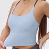 A light blue women's athletic crisscross tank top worn by a model.