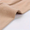 Close-up of beige compression stockings showing ribbed texture and elastic cuff.