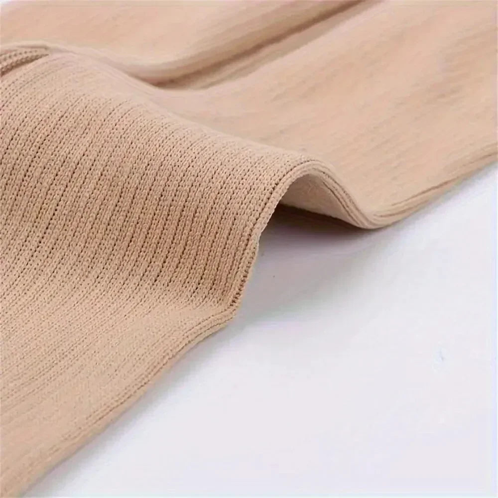 Close-up of beige compression stockings showing ribbed texture and elastic cuff.