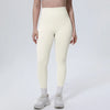 A model wearing high-waisted, light beige quick-drying yoga and fitness leggings and white socks.