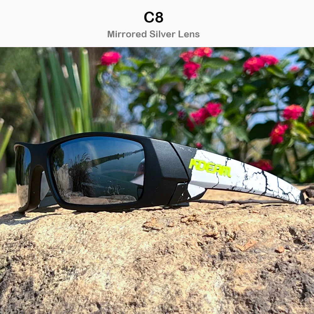 A pair of black mirrored silver lens sunglasses resting on a rough, light-colored rock outdoors.