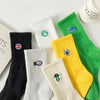 A collection of men's athletic embroidered crew socks in various colors including black, white, yellow, and green.