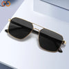 A pair of classic square aviator sunglasses with gold accents resting on a white surface.