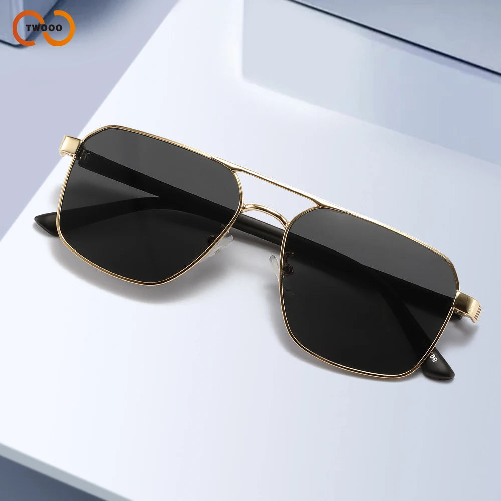 A pair of classic square aviator sunglasses with gold accents resting on a white surface.