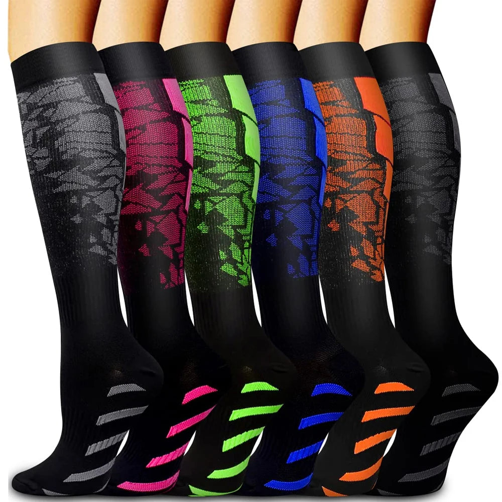 A row of black compression socks in various bright colors, including pink, green, blue, orange, and yellow.