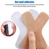 A hand is applying a piece of tan kinesiology tape to the skin, demonstrating its use for enhancing skin wrinkles and athleti